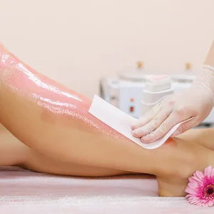 Applying-wax-to-a-young-woman_s-leg-for-hair-removal_1024x400